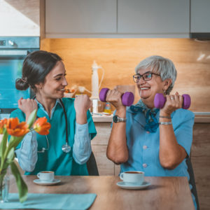 Two women working with hand weights